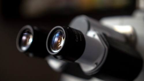 Closeup of a microscope eyepiece in a lab